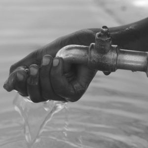 Oxfam International - A hand being cleansed with fresh water in Eastern Africa