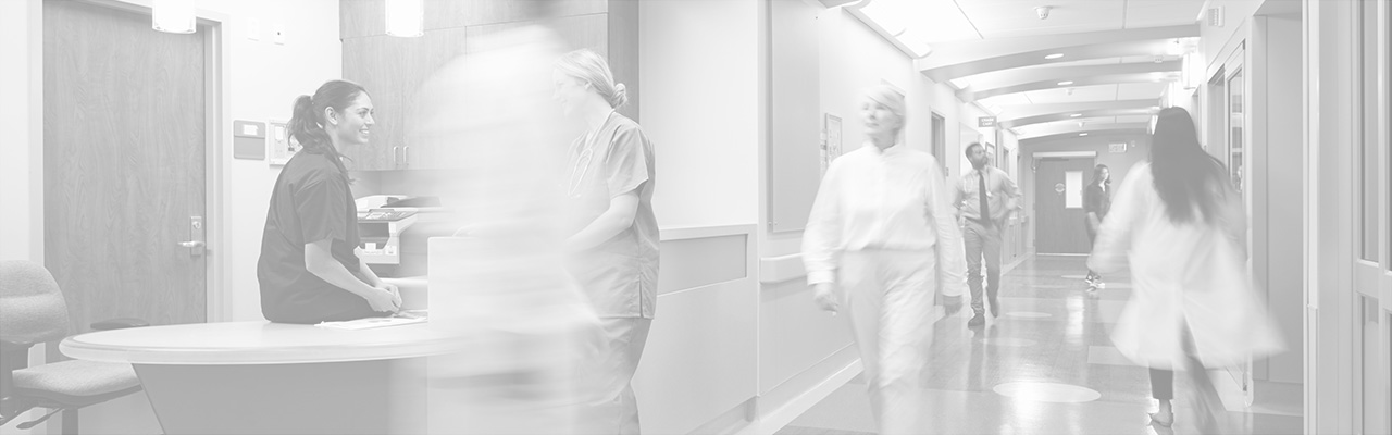 Healthcare workers walk through a hospital hallway